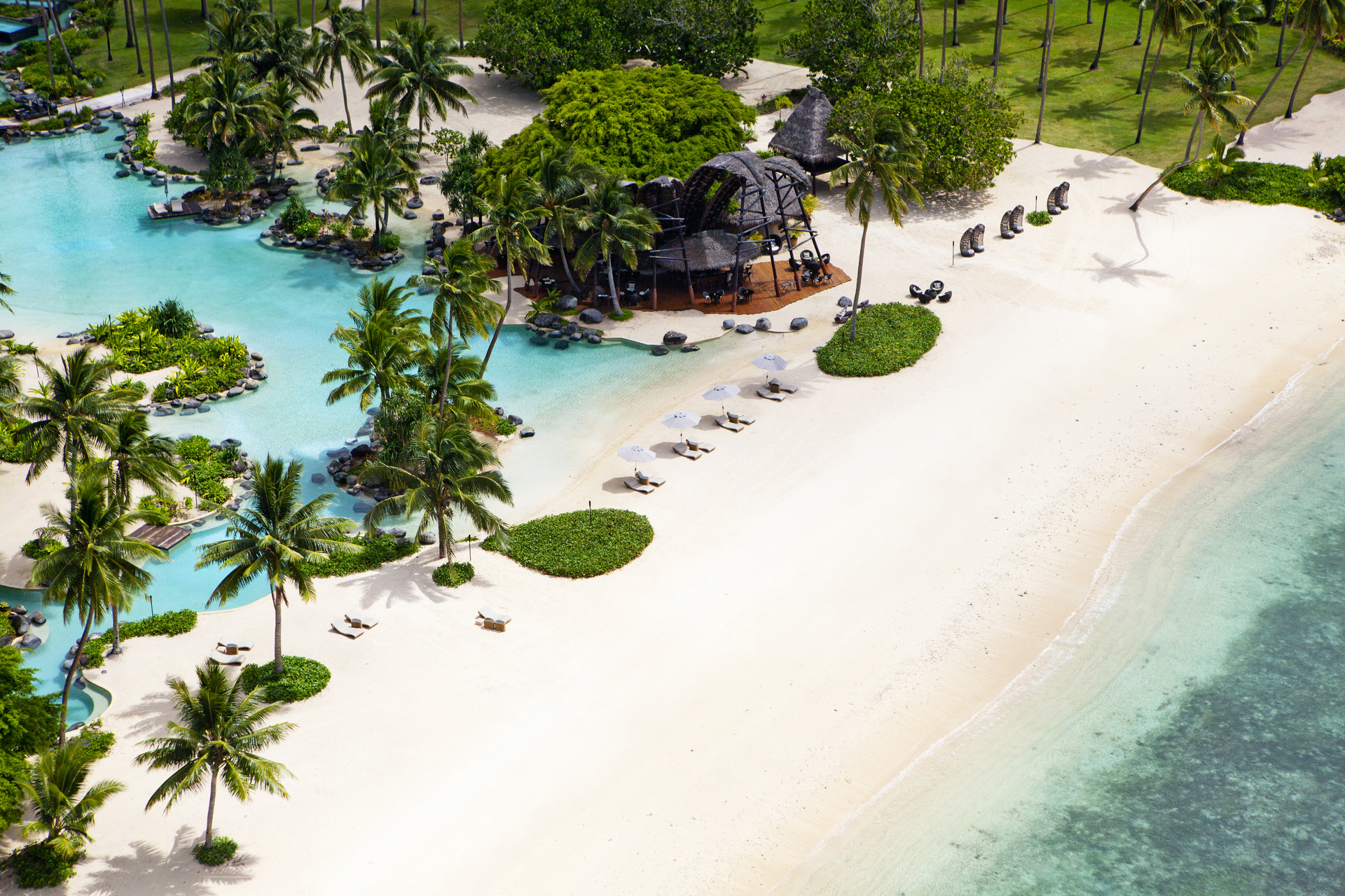 laucala island from the air, beach, palm trees and hotel resort