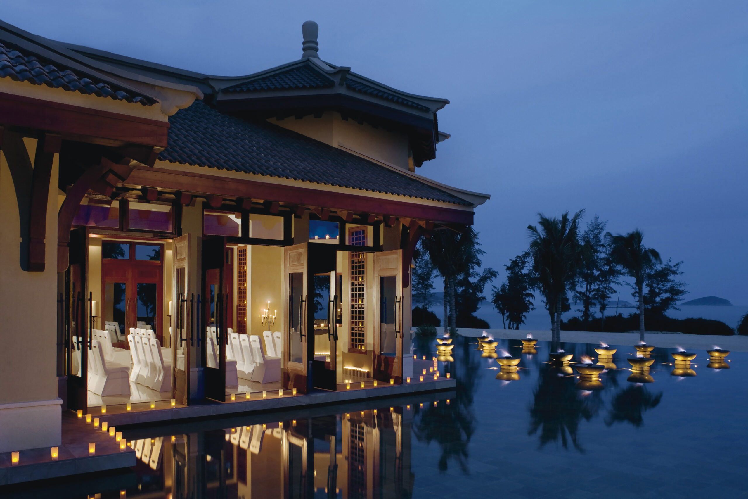contemporary chinese architecture at Ritz Carlton Sanya overlooking the pool with candle lanterns floating