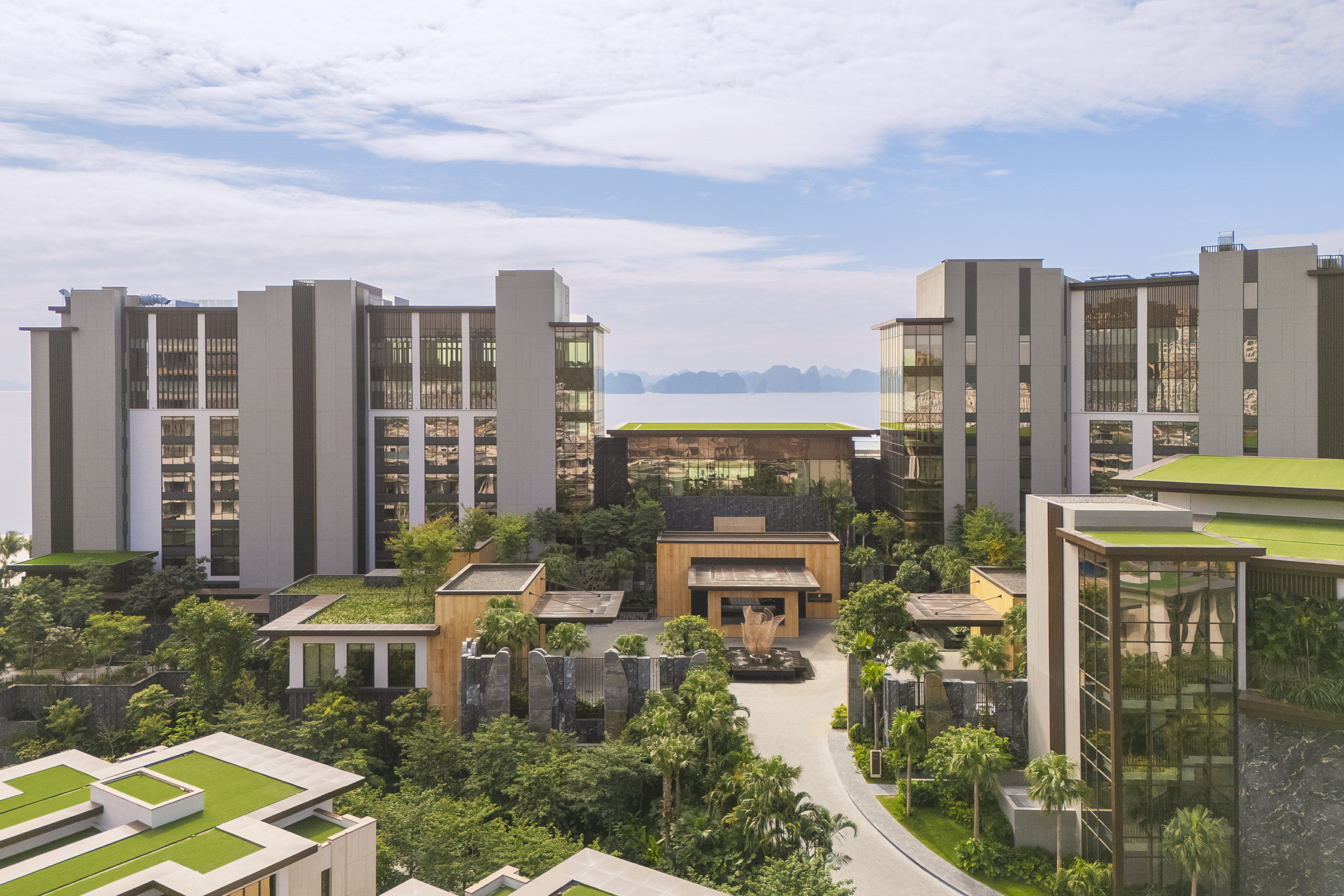 Bird's-eye rendering of the full branded residence complex showing tower blocks, villa clusters, and resort-scale landscaping, InterContinental Halong Bay by WATG