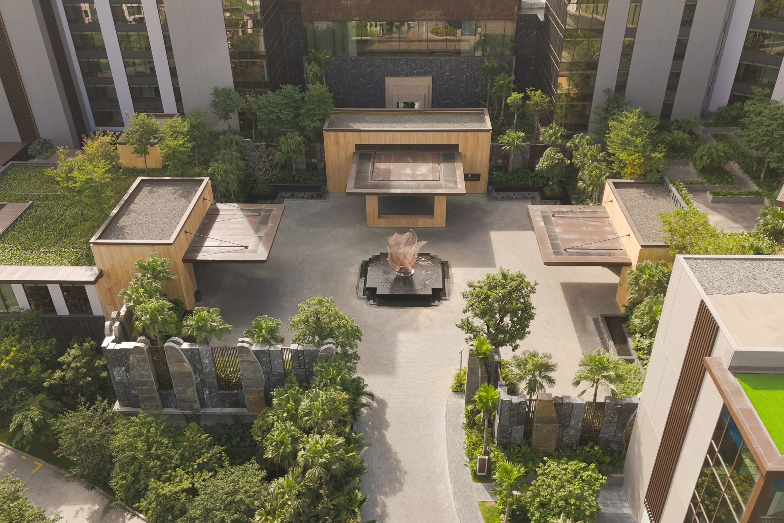 Aerial rendering showing the resort's landscaped courtyard network with pools, pavilions, and villa rooftops, InterContinental Halong Bay by WATG