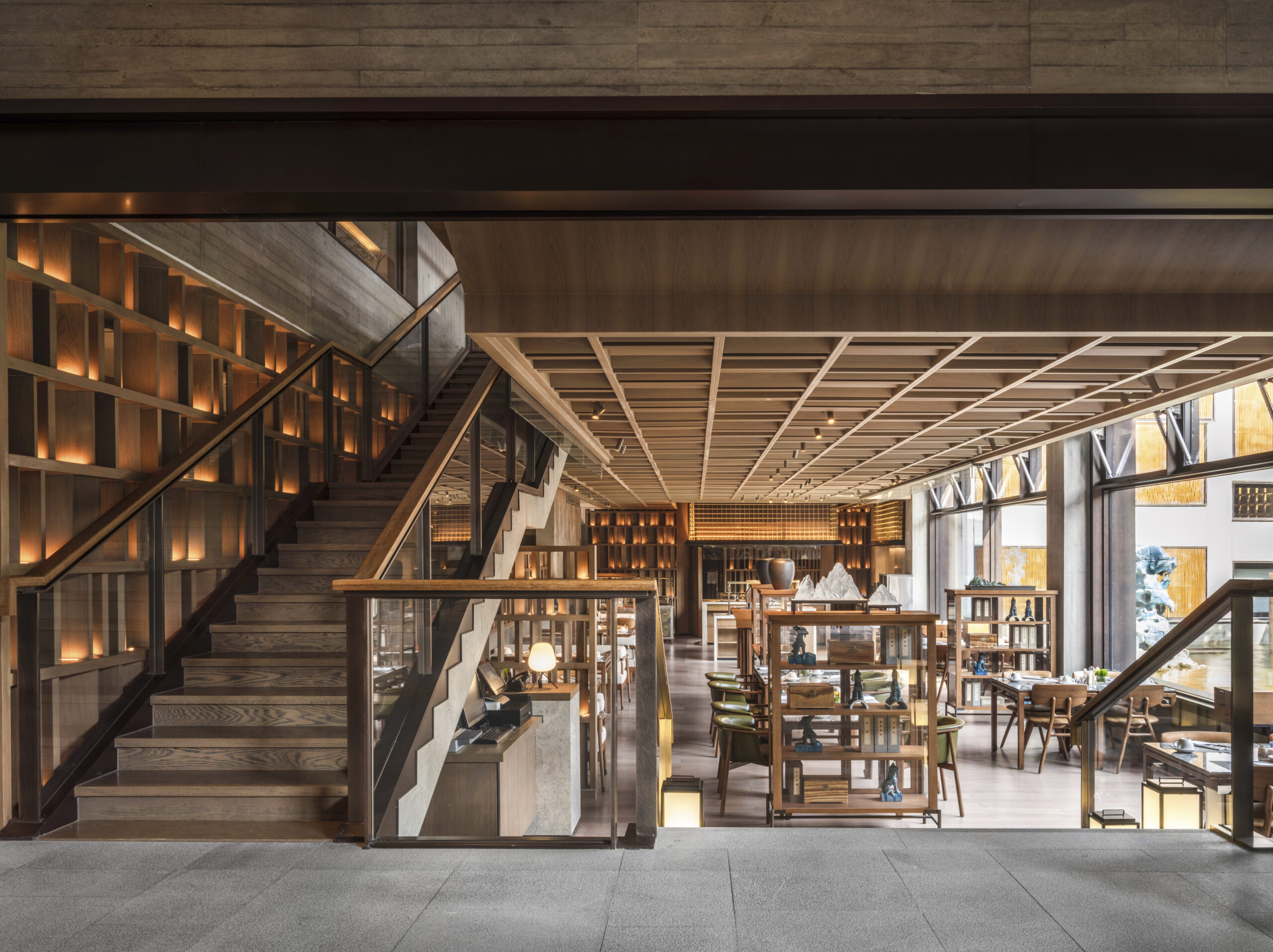 wood and stone interior looking from lobby to the lobby lounge at yanbai villa, china