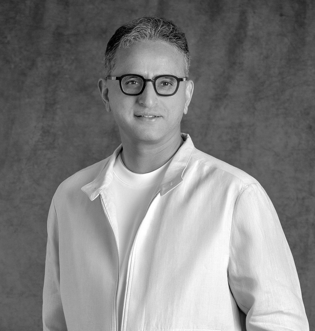 Portrait of Raghavendra Shanbhag, Associate Principal, WATG, standing against a grey backdrop.