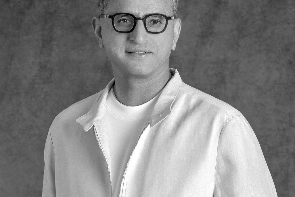Portrait of Raghavendra Shanbhag, Associate Principal, WATG, standing against a grey backdrop.