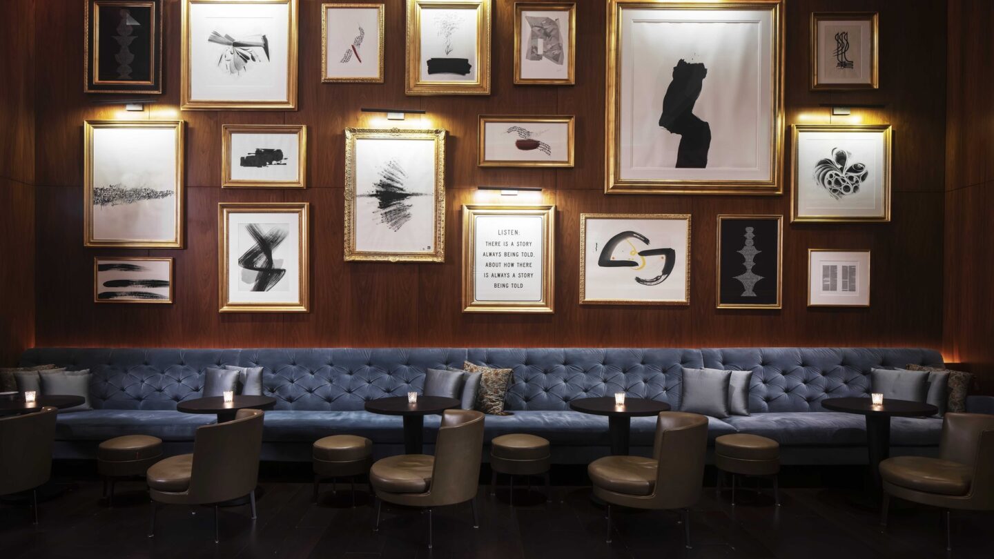 A modern restaurant table with a living, biophilic wall