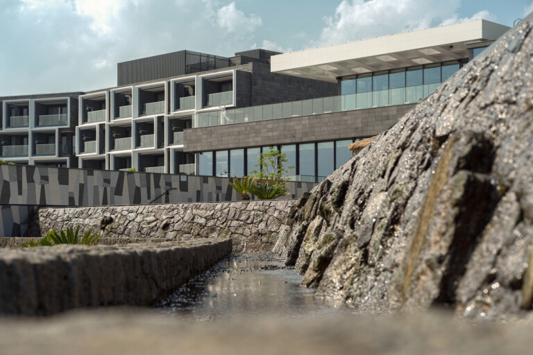 JW Marriot Jeju exterior architecture with rocks in foreground