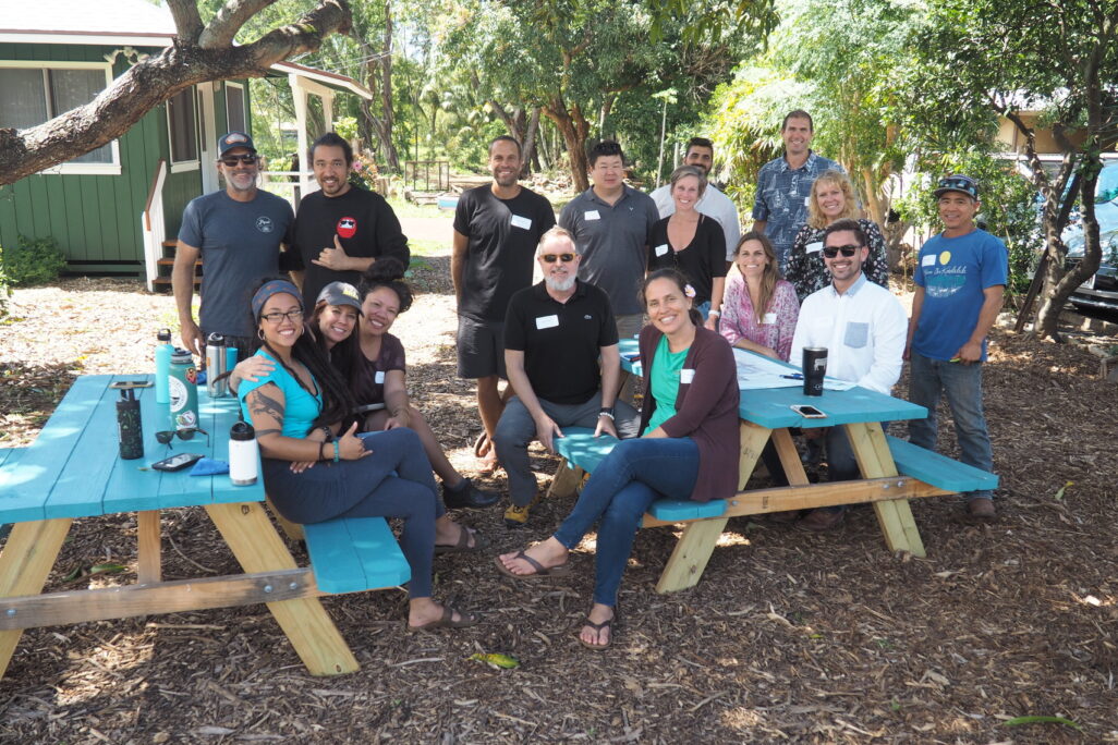 watg staff working outside on a bench