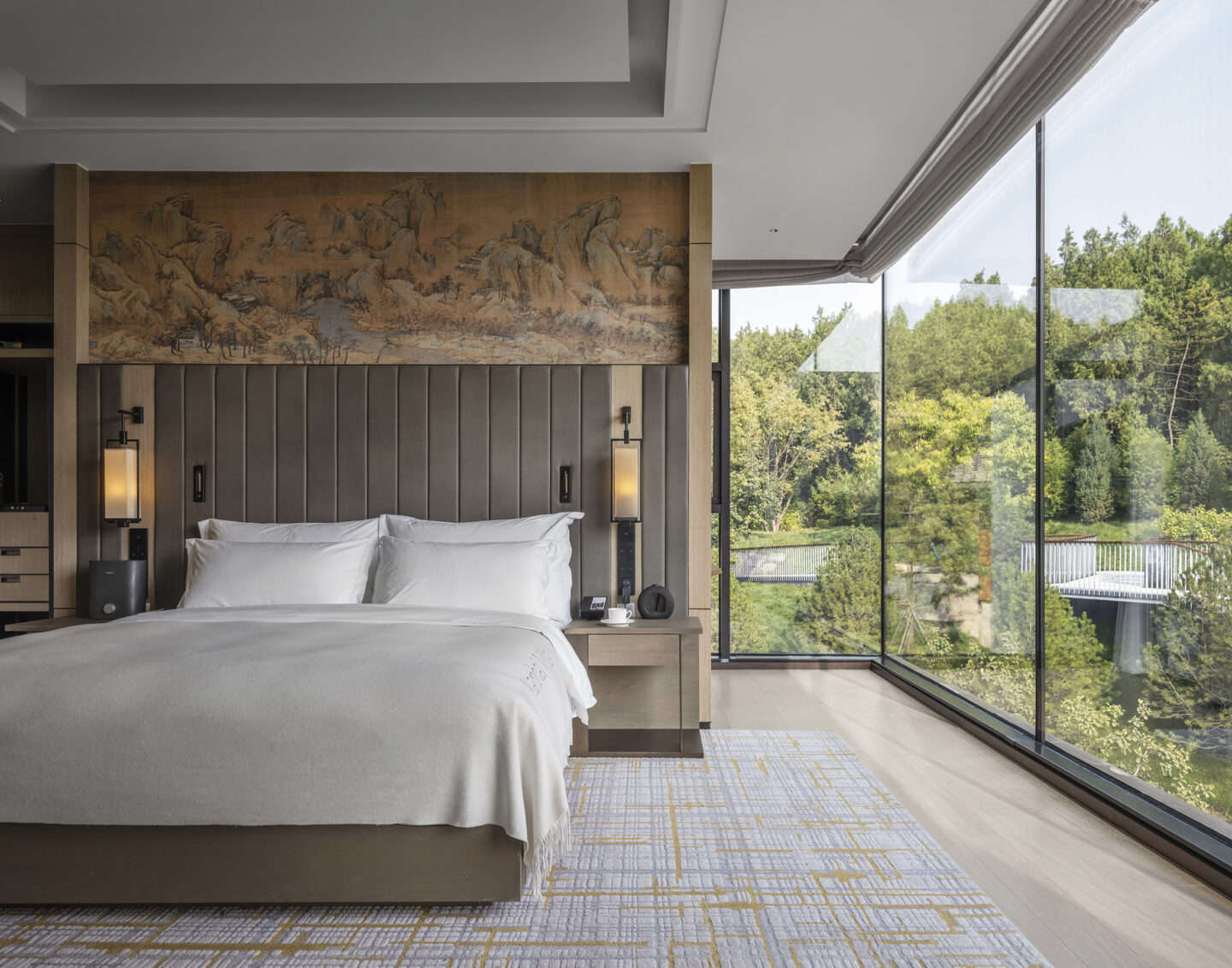 yanbai villas guestroom with chinese mural and floor to ceiling windows looking over the landscape
