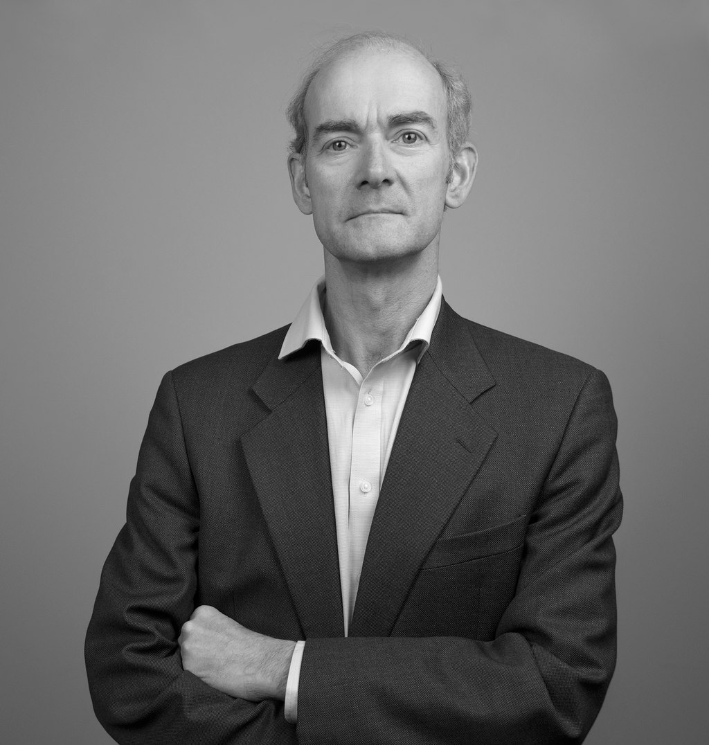 Black and white portrait of Alasdair Maclean, WATG, against a grey backdrop.