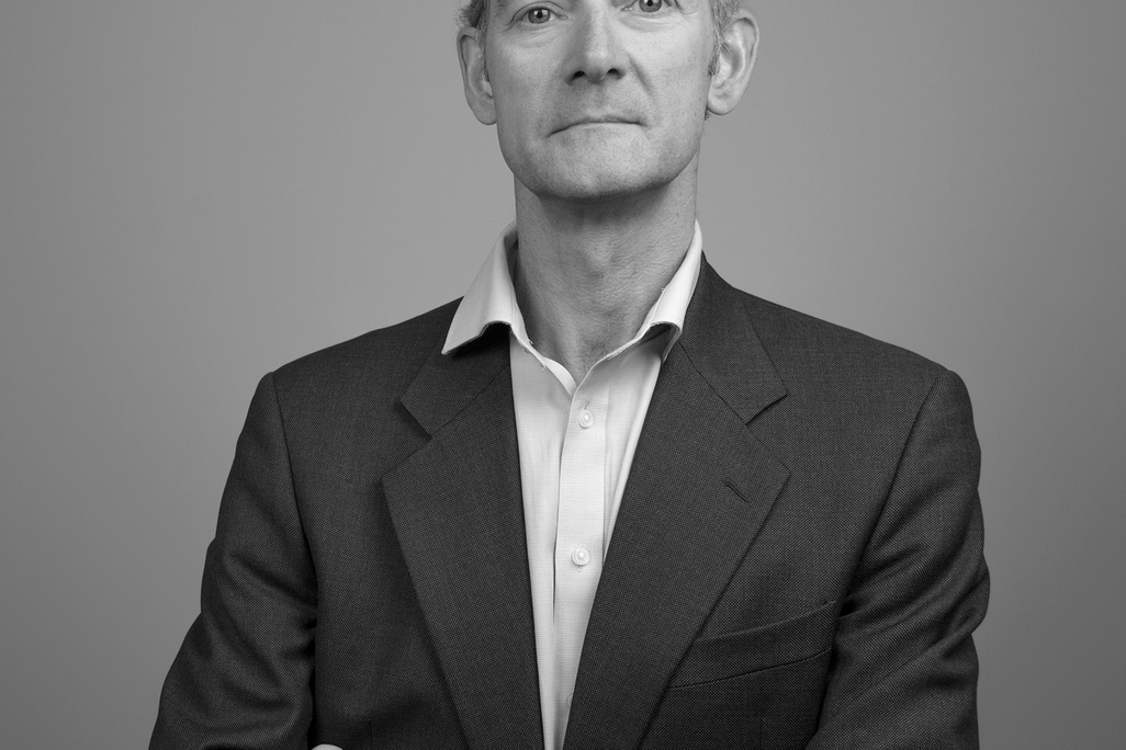 Black and white portrait of Alasdair Maclean, WATG, against a grey backdrop.