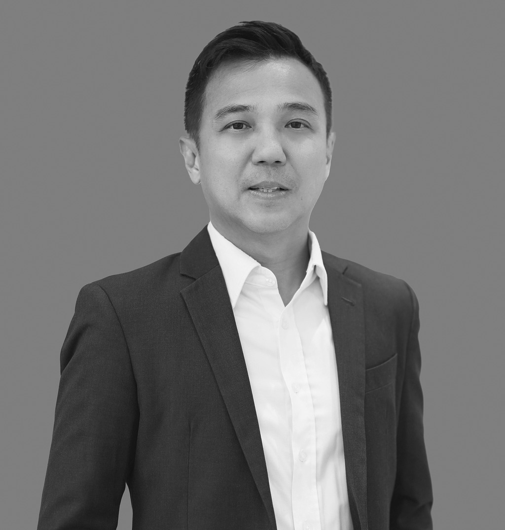 Portrait of Kit Hung Lee, Associate Principal, WATG, standing against a grey backdrop.