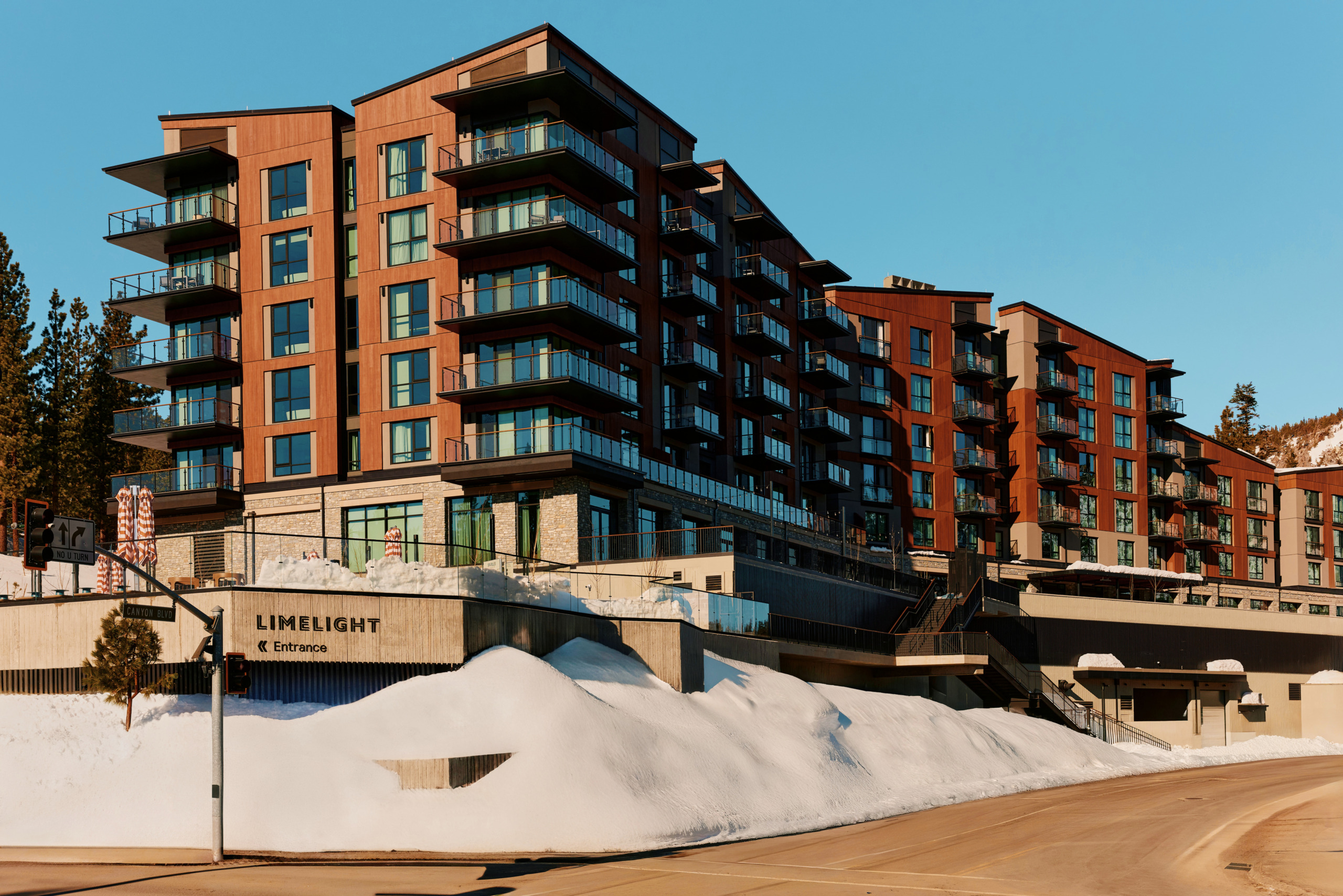 Street-level exterior of Limelight Hotel Mammoth Lakes with contemporary façade, snow-covered surrounds, and mountain backdrop, designed by WATG