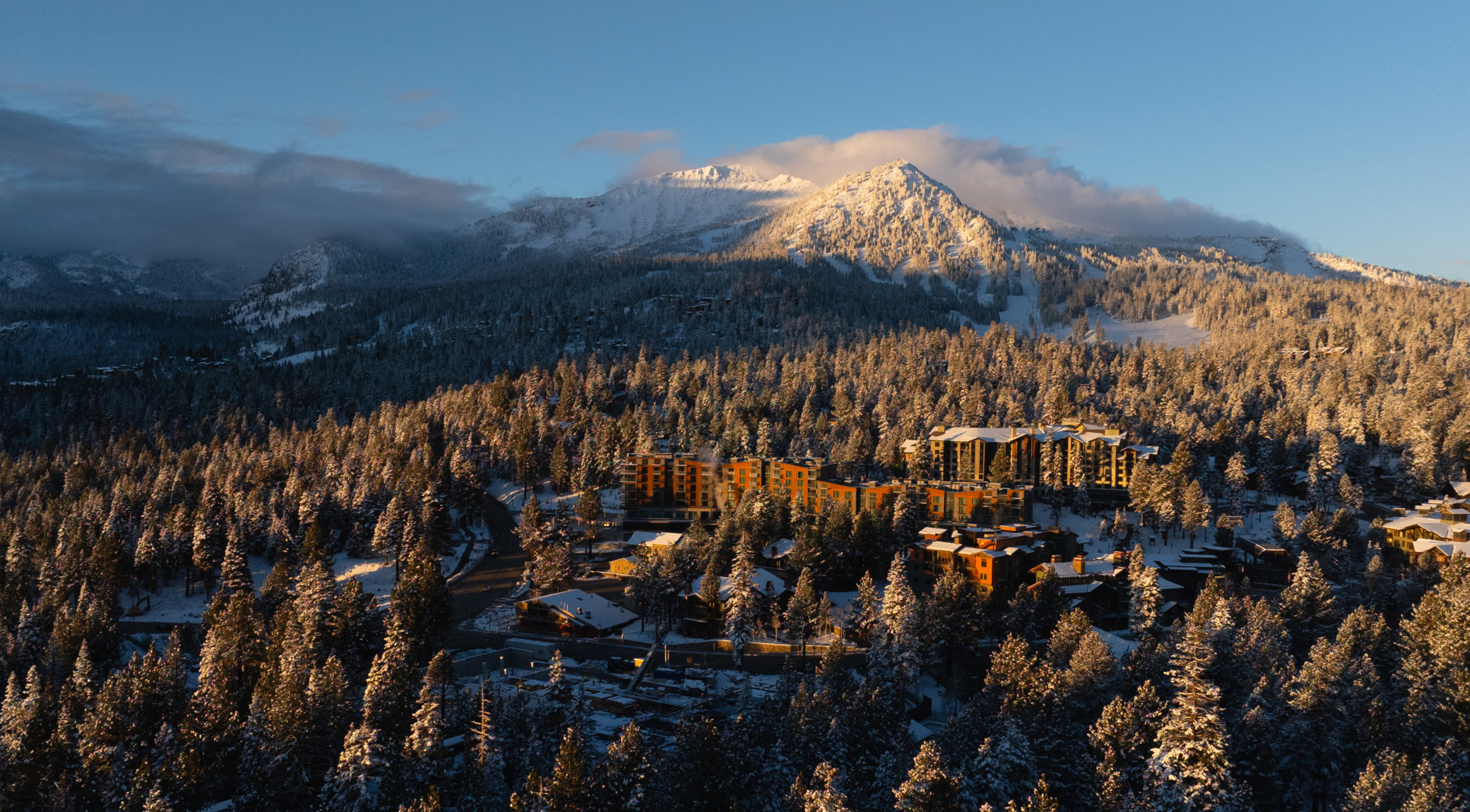 Wide aerial view of Mammoth Lakes valley and surrounding mountain range in winter conditions, Limelight Hotel Mammoth Lakes by WATG