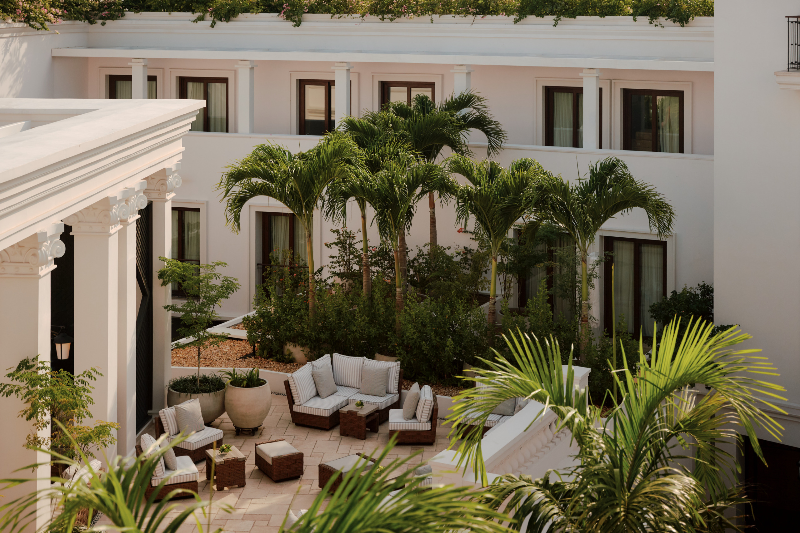 Outdoor terrace at Four Seasons Cartagena with tropical landscaping and lounge seating