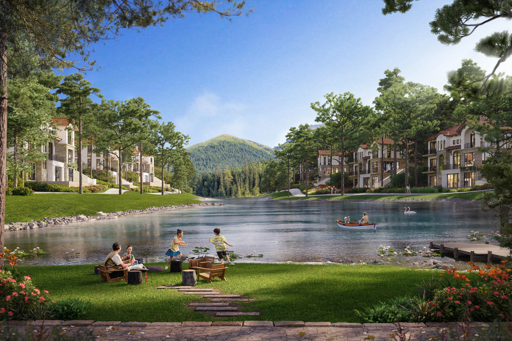 Daytime render of Thanh Xuan Valley's residential villas lining a pine-forested lakeshore, with families relaxing on the grass, children playing by the water, and a rowboat and swans on the lake, mountains visible in the background.