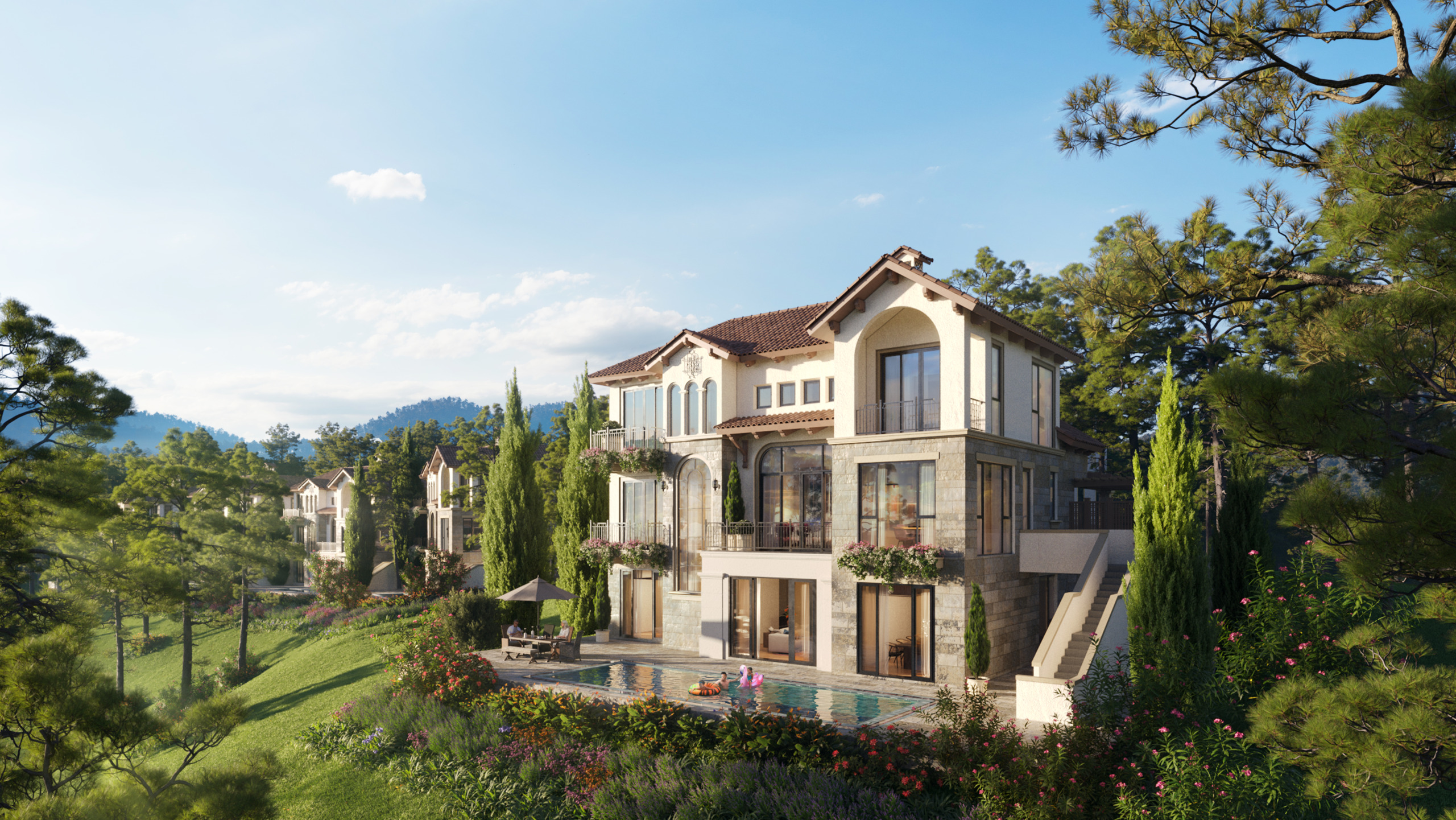 Daytime render of a Thanh Xuan Valley residential villa, a three-storey Mediterranean-style stone and stucco home with a terracotta roof and private pool terrace, set on a wooded hillside among cypress trees with other villas visible in the background.